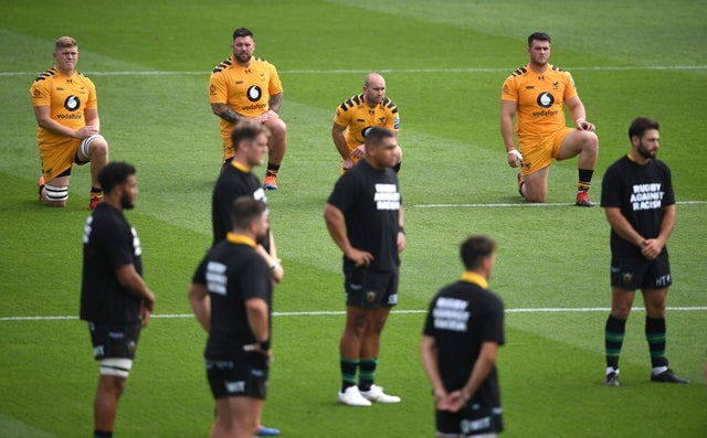 Wasp players take a knee as Northampton Saints stand prior to kick-off in their Premiership match at Franklin's Gardens