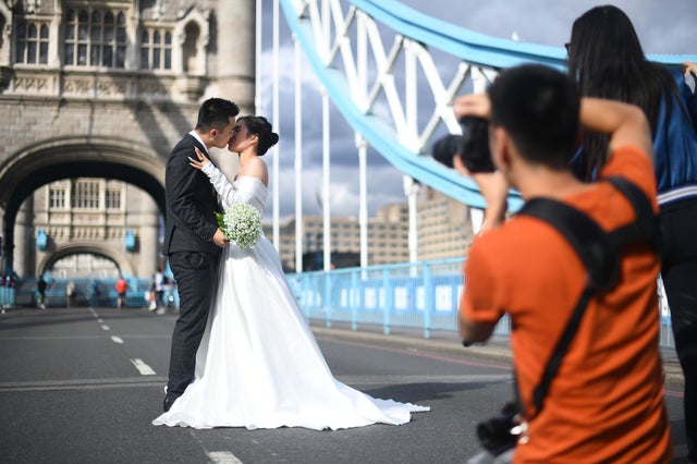 Jenny Nguyen and Tony Cao, from Vietnam, pose for wedding photos on Tower Bridge in London, as it remains closed to vehicles after it was stuck open on Saturday due to a "mechanical fault". The landmark's Twitter account confirmed only pedestrians and cyclists could use it on Sunday morning