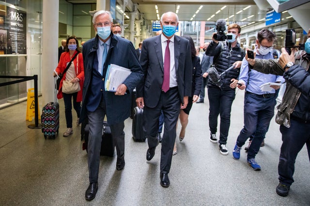 EU's chief negotiator Michel Barnier, left, arriving from the Eurostar with EU Ambassador to the UK, Portuguese diplomat Joao Vale de Almeida at St Pancras International railway station, London, for the latest round of the negotiations on a free trade deal between the EU and the UK