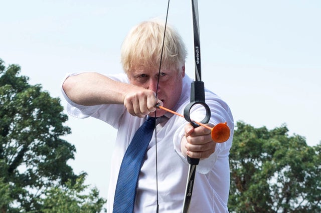 Prime Minister Boris Johnson takes part in an archery session as he visits Premier Education Summer Camp at Sacred Heart of Mary Girls' in Upminster