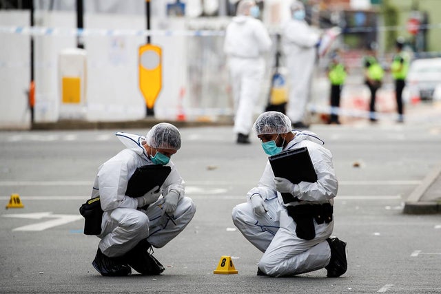 Forensics officers near the scene of multiple reported stabbings in Birmingham