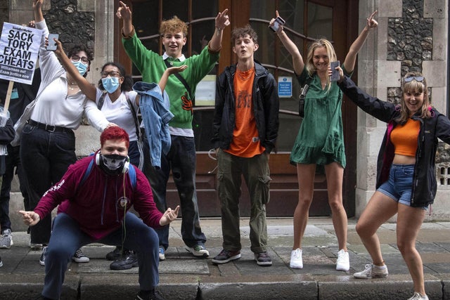 A level students celebrate outside the Department for Education in London after it was confirmed that candidates in England will be given grades estimated by their teachers, rather than by an algorithm. The government U-turn comes just days after Education Secretary Gavin Williamson vowed there would be "no U-turn, no change. 