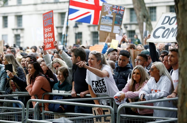 A protester reacts as she demonstrates against the lockdown and use of face masks, amid the coronavirus disease outbreak, outside Downing Street in London