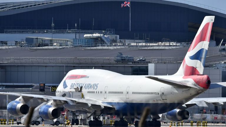 An Airbus A747 passenger jet is moved by an aircraft tractor at Heathrow Airport