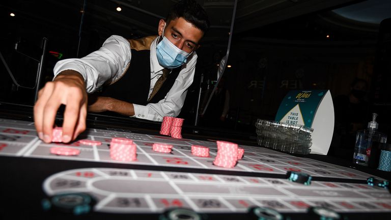 Staff clean chips with antibacterial wipes at The Rialto casino in central London as they prepare for reopening at midnight as coronavirus lockdown measures continue to be eased in England. PA Photo. Picture date: Friday August 14, 2020. See PA story POLITICS Coronavirus. Photo credit should read: Kirsty O'Connor/PA Wire