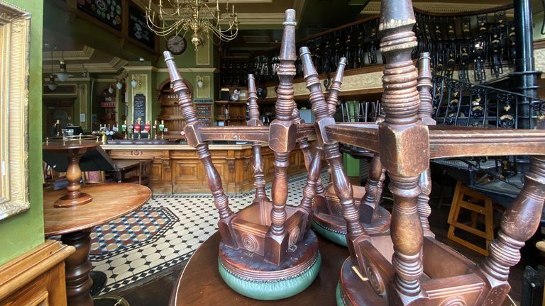 Upturned stools are seen on a table inside the Butchers Hook & Cleaver pub, owned by Fuller's, in London, Britain, July 3, 2020