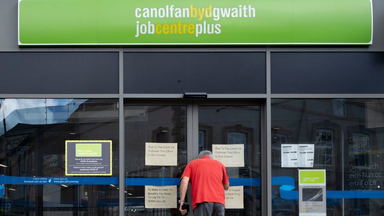 A man looks through the window of the Job Centre Plus on August 18, 2020 in Bargoed, Wales.