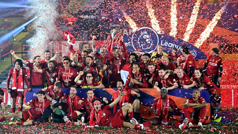 LIVERPOOL, ENGLAND - JULY 22: Jordan Henderson of Liverpool lifts The Premier League trophy following the Premier League match between Liverpool FC and Chelsea FC at Anfield on July 22, 2020 in Liverpool, England. Football Stadiums around Europe remain empty due to the Coronavirus Pandemic as Government social distancing laws prohibit fans inside venues resulting in all fixtures being played behind closed doors. (Photo by Paul Ellis/Pool via Getty Images)