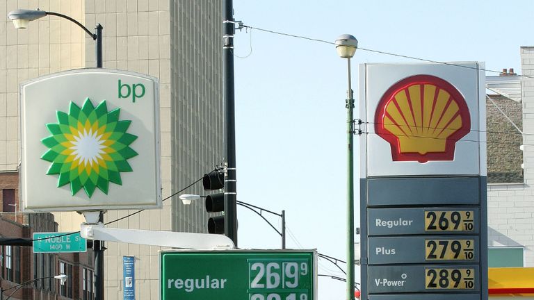 CHICAGO - JANUARY 12: A motorist in her SUV departs a BP Amoco gas station adjacent a Shell Oil gas station January 12, 2006 in Chicago, Illinois. Oil prices have risen on concerns of Iran's reported possible nuclear development. (Photo by Tim Boyle/Getty Images)