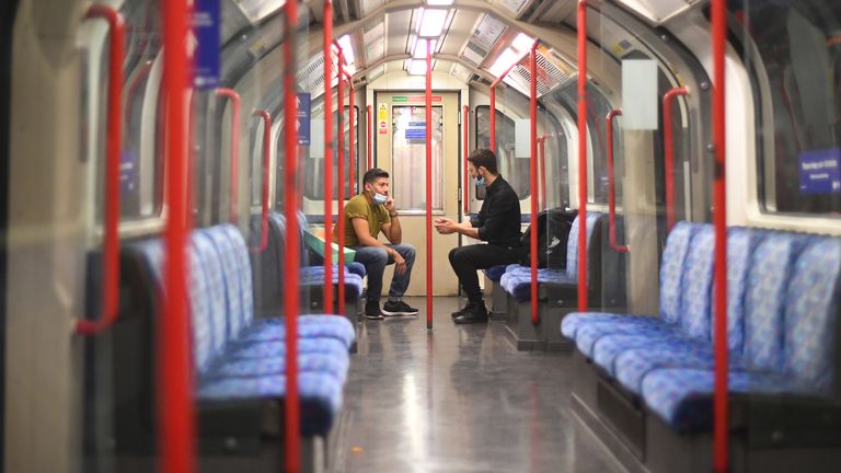 Passengers on a Central Line underground train, after a range of new restrictions to combat the rise in coronavirus cases came into place in England.