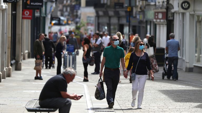 Embargoed to 0001 Monday July 13 File photo dated 14/06/20 of people walking along the High street in Winchester. Retail footfall for June more than halved against the same month last year as shopper demand remains low despite the "turning point" of reopening thousands more stores.